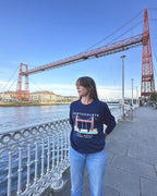 Sudadera IZENA Portugalete · Puente Bizkaia – en el paseo, con el puente y Las Arenas al otro lado